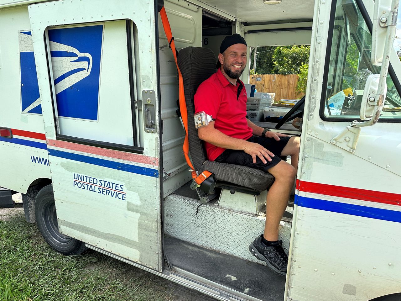 Juan Carlos Ocasio in his mail truck along his rural route in Moon Lake on Sept. 18, 2023. (Spectrum News)